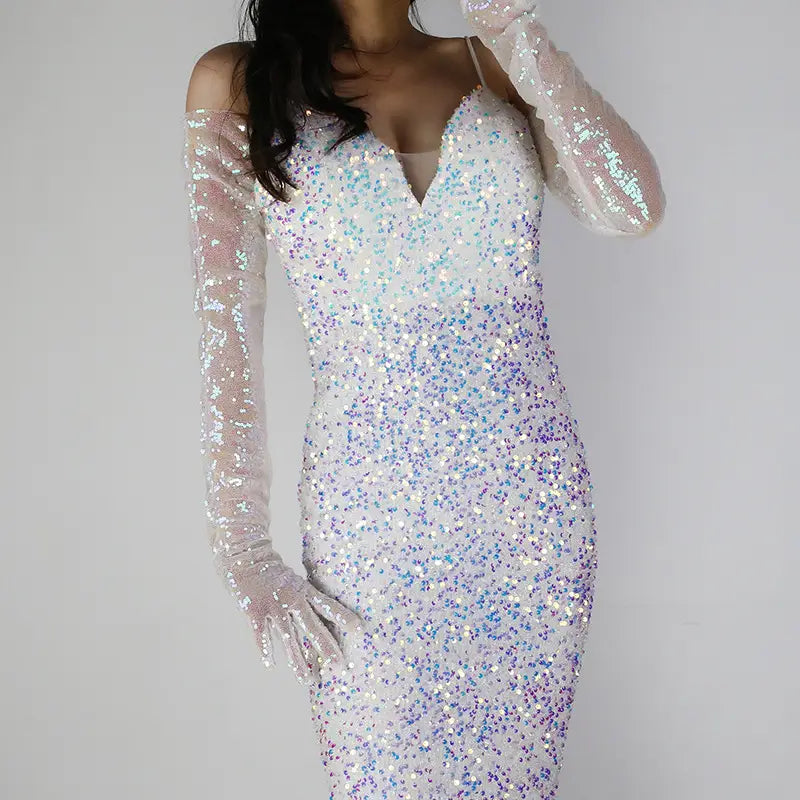 A shimmering iridescent sequined bodycon dress with a v-neckline featuring gradient hues of white to blue-purple paired with long sheer mesh finger gloves.