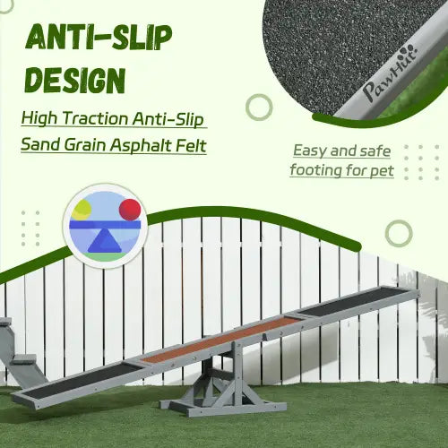 Silver metal dog agility seesaw training equipment with black sand grain asphalt felt surface and green trim.