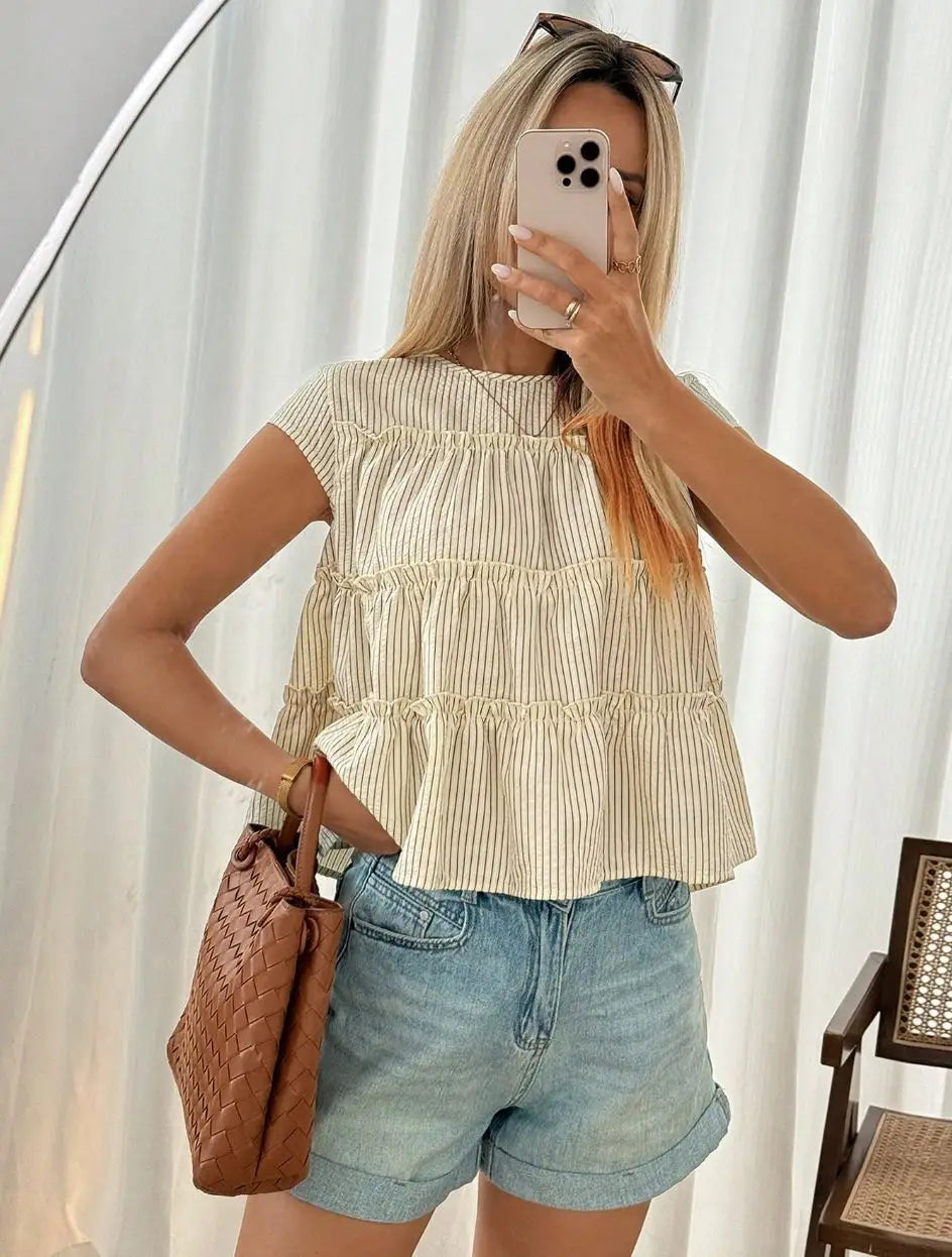 Beige and cream striped tiered blouse with ruffled hem designed in lightweight fabric for casual wear.