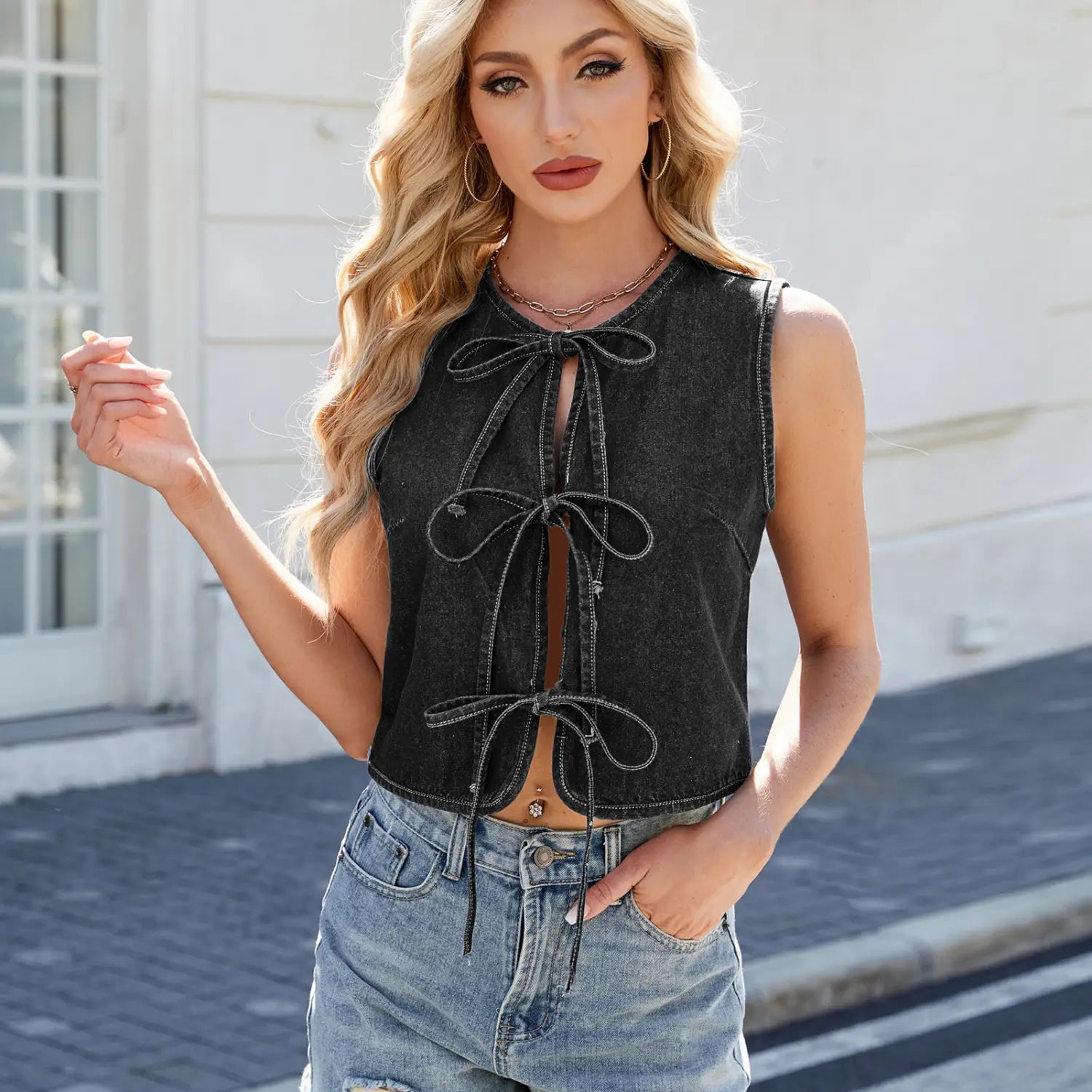 Black denim sleeveless crop top with front tie details in a Y2k bow tie design.