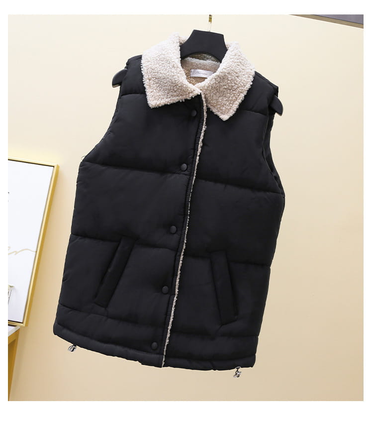 Black quilted vest for women featuring a plush cream-colored shearling collar and front button closure.
