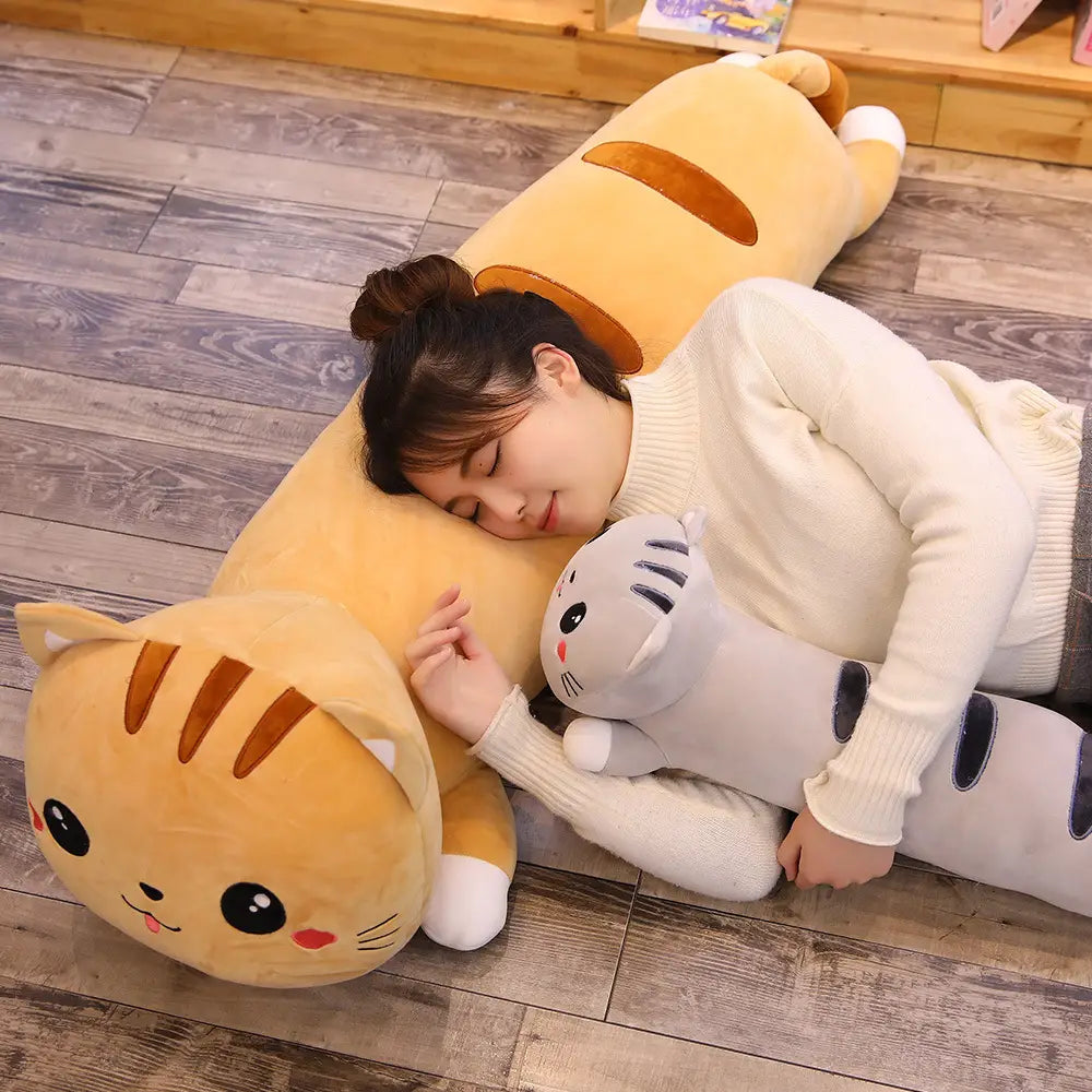 A long, plush orange cat-shaped pillow with brown stripes and white paws is a soft stuffed animal toy for cozy comfort.