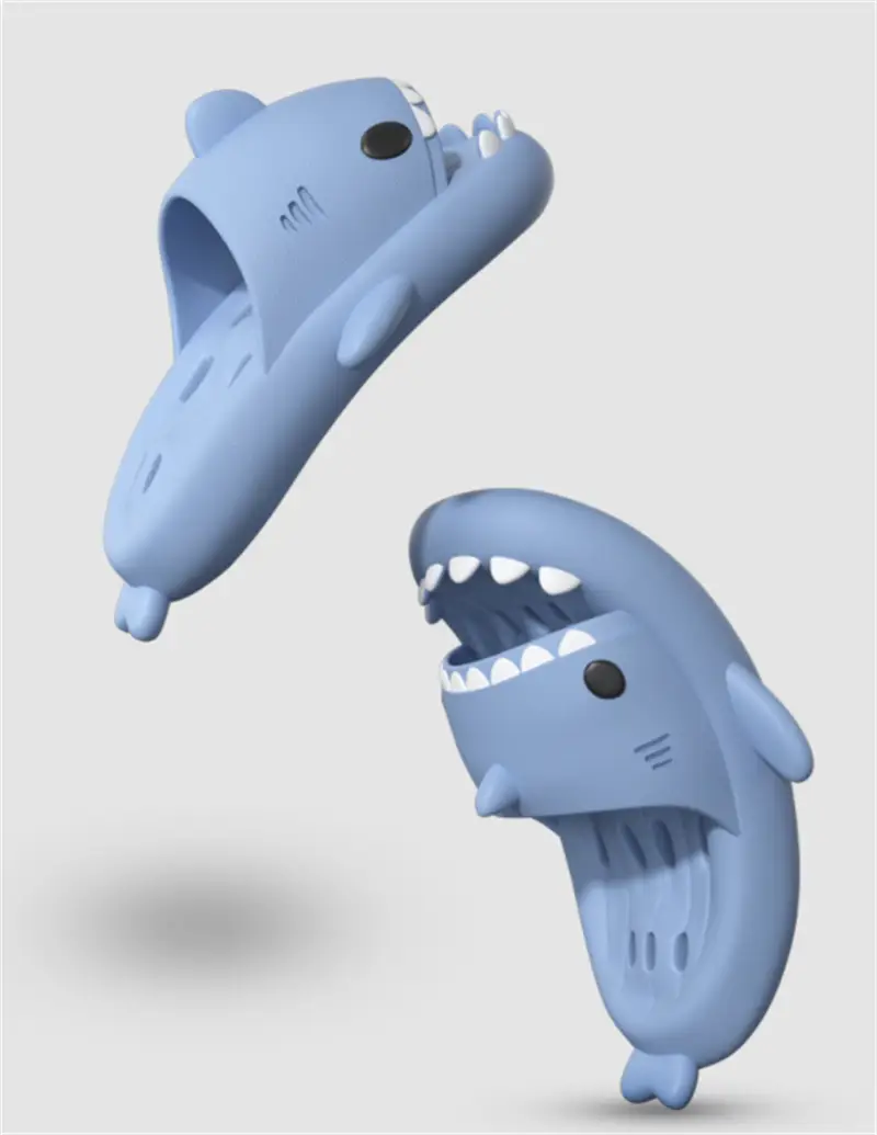 Light blue shark-themed quick dry non slip shower slide sandals featuring white teeth and black eyes in a playful cartoonish design.