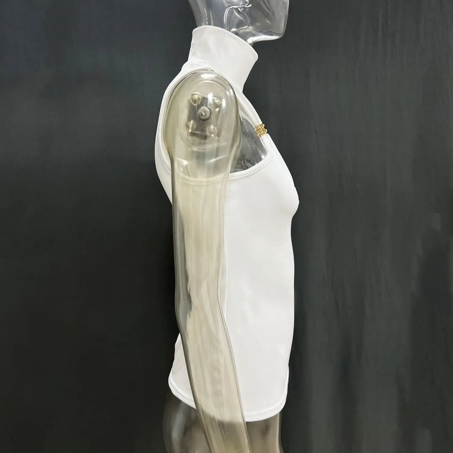 A white sleeveless gold ring halter stretch top with a high neckline displayed on a transparent mannequin.