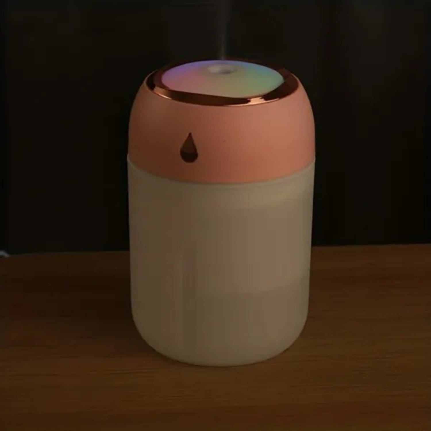 A sleek cylindrical ultrasonic USB desktop humidifier featuring a matte peach-colored top and a translucent white body with a night light.