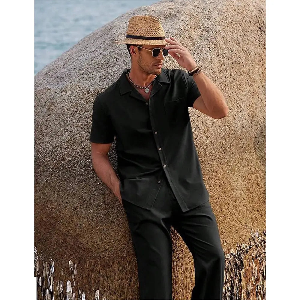 Man wearing a black short sleeve shirt and matching trousers set made of lightweight fabric suitable for casual and formal occasions