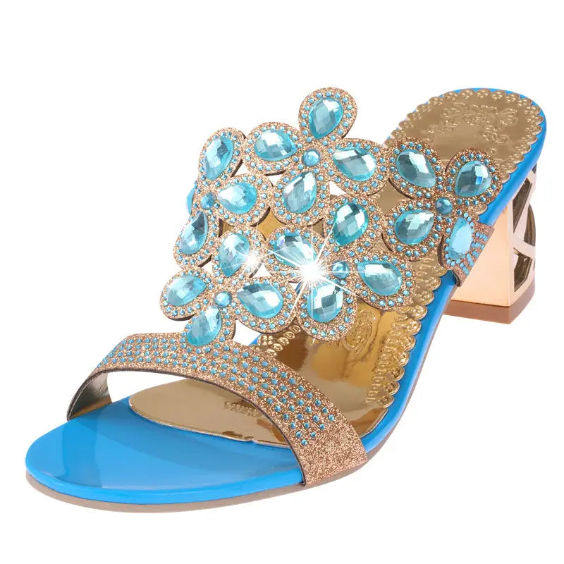 Bright blue satin rhinestone high heel sandal with a gold-tone block heel and ornate floral design embellished with turquoise teardrop-shaped rhinestones.