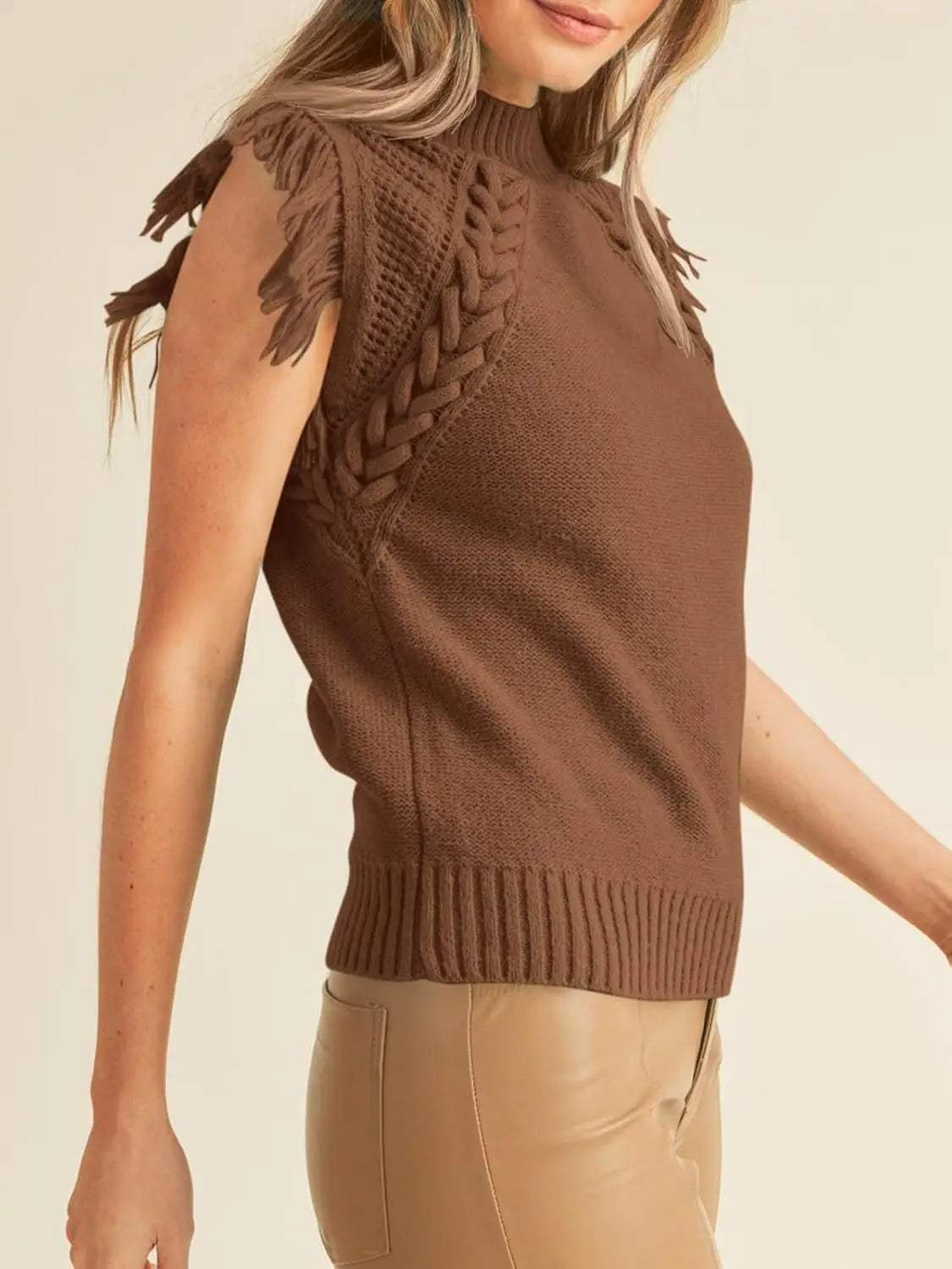 Brown hand-woven sleeveless knit sweater vest with braided texture and fringe detailing along the shoulders.