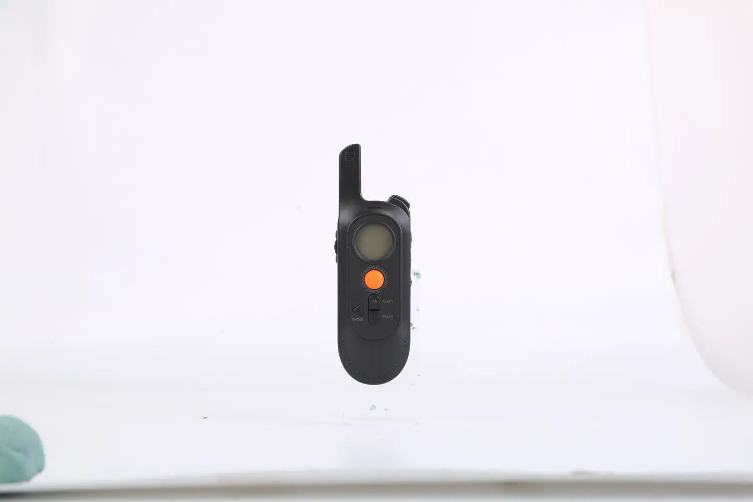 dog training collar remote in black with an orange button and small digital display for 984ft waterproof use with voice record feature.