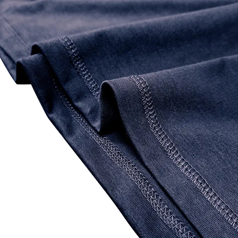 dark blue cotton contrast trim short sleeve henley polo shirt with subtle textured weave and reinforced stitching along the hem