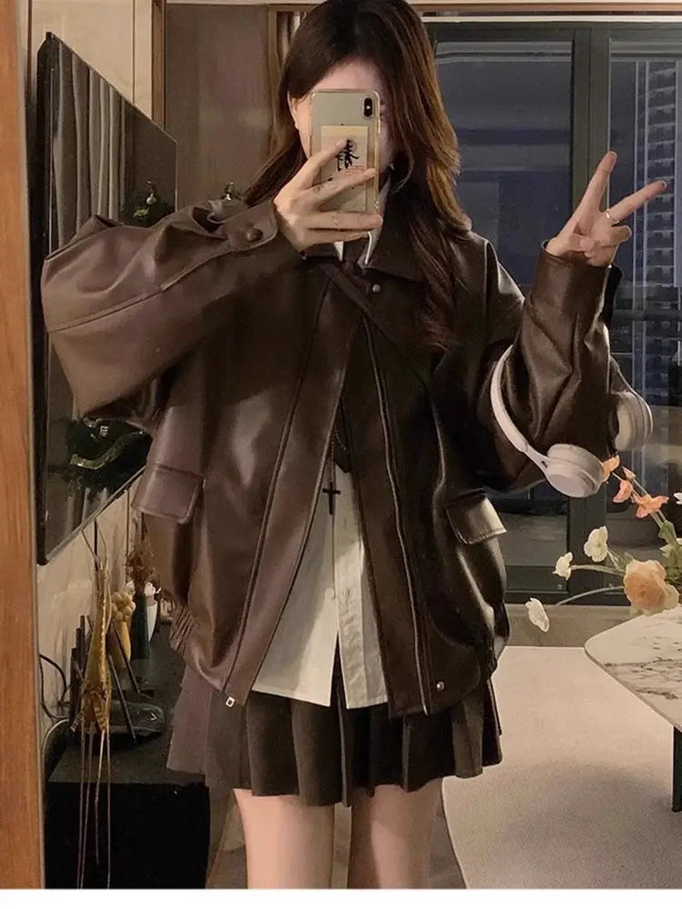 Brown faux leather bomber jacket oversized short coat with flap pockets and a collar.