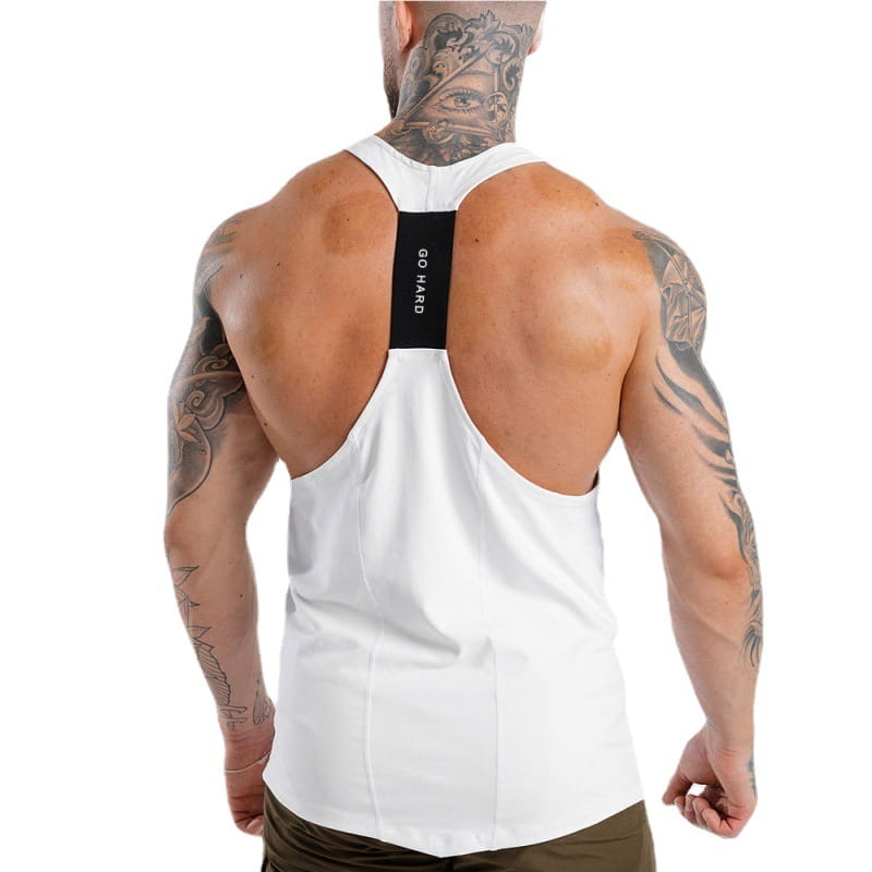 Back side of a men’s white racerback athletic tank top featuring a black vertical stripe with go hard text in white.