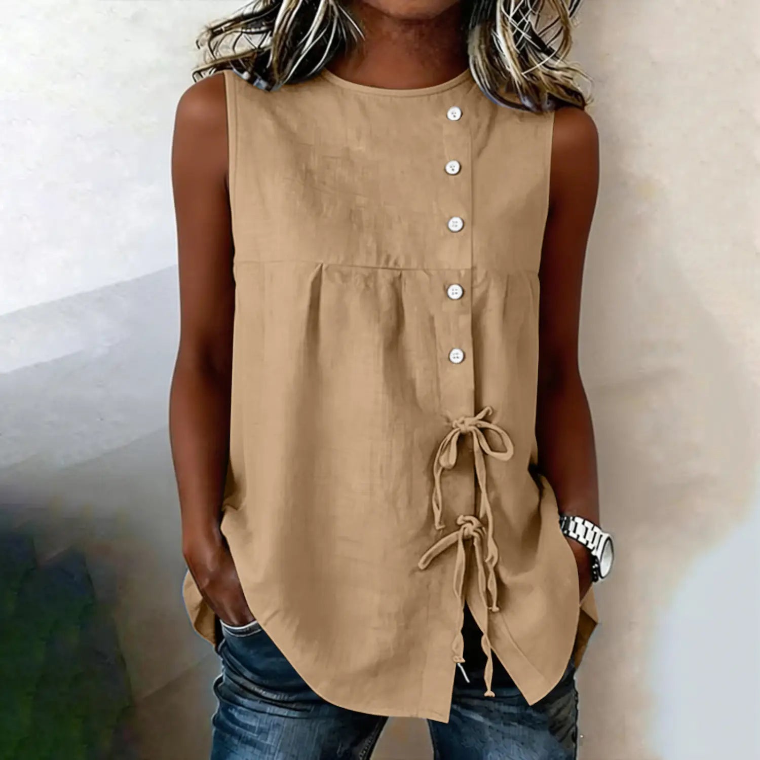 Beige sleeveless tie side button down blouse featuring a gathered waist and side ties for a flattering fit.