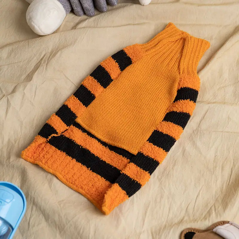 orange and black striped knitted Halloween dog sweater pumpkin knit pet costume featuring a ribbed high neck and cuffs