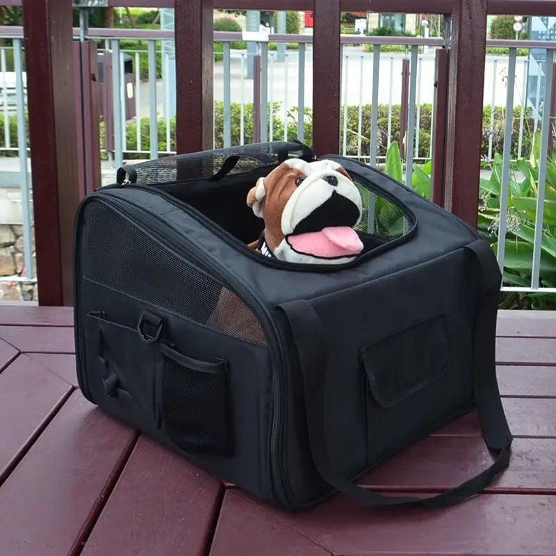 Black mesh pet carrier backpack for small dogs and cats with a plush bulldog toy peeking out from the top opening.