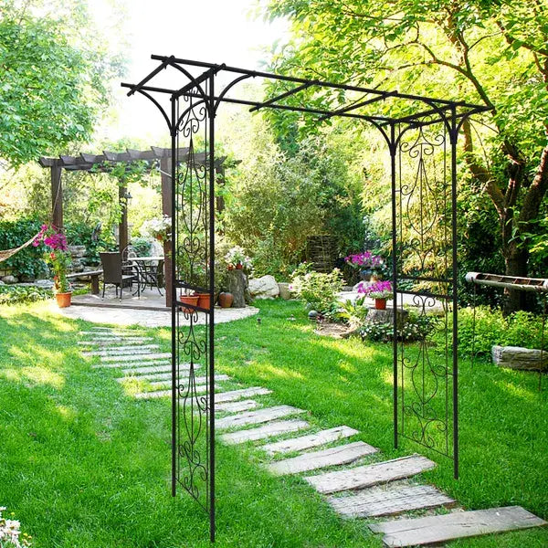 Black wrought iron garden arbor with ornate scrollwork design and rose motif suitable for outdoor garden decoration.