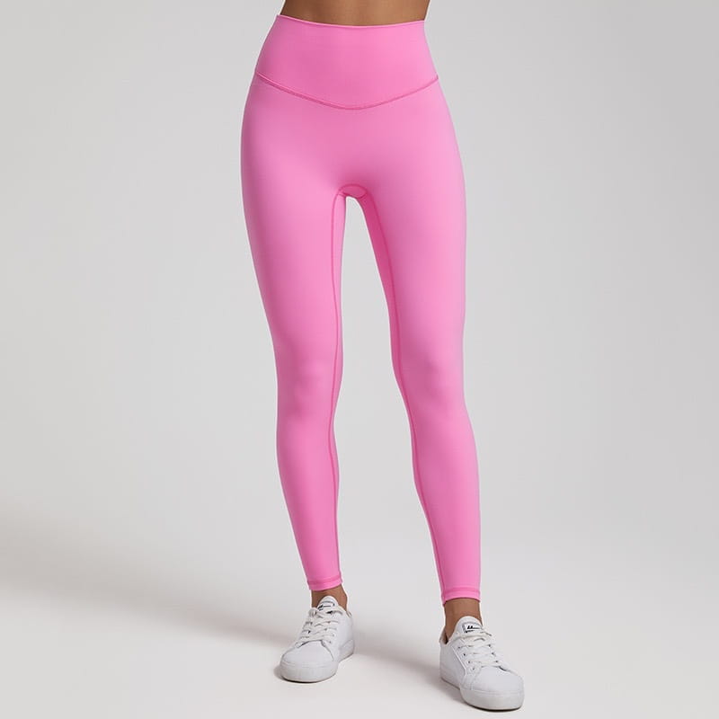 Bright pink high waisted stretch fitted leggings made of stretchy form fitting fabric.