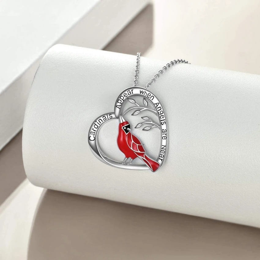 silver cardinal heart engraved pendant necklace featuring a red cardinal perched on an engraved tree branch with the inscription cardinals appear when angels are near