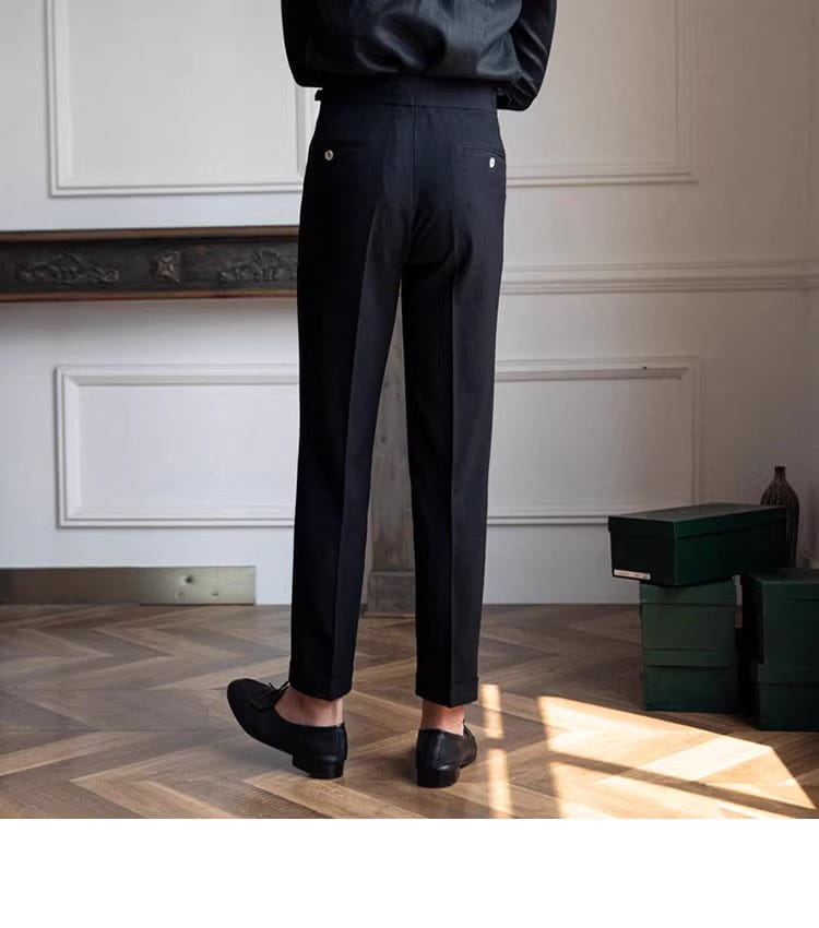 Black slim fit pleated summer linen suit trousers for men featuring subtle pleats and silver button accents.