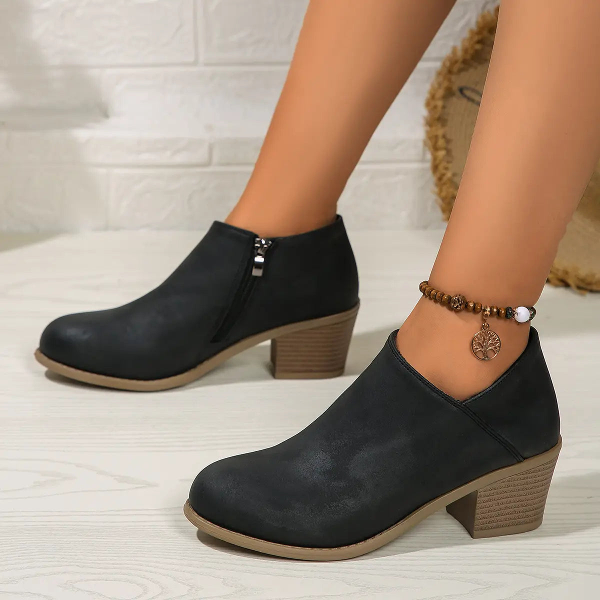 suede ankle boots with chunky wooden block heel and textured black upper featuring a side zipper closure