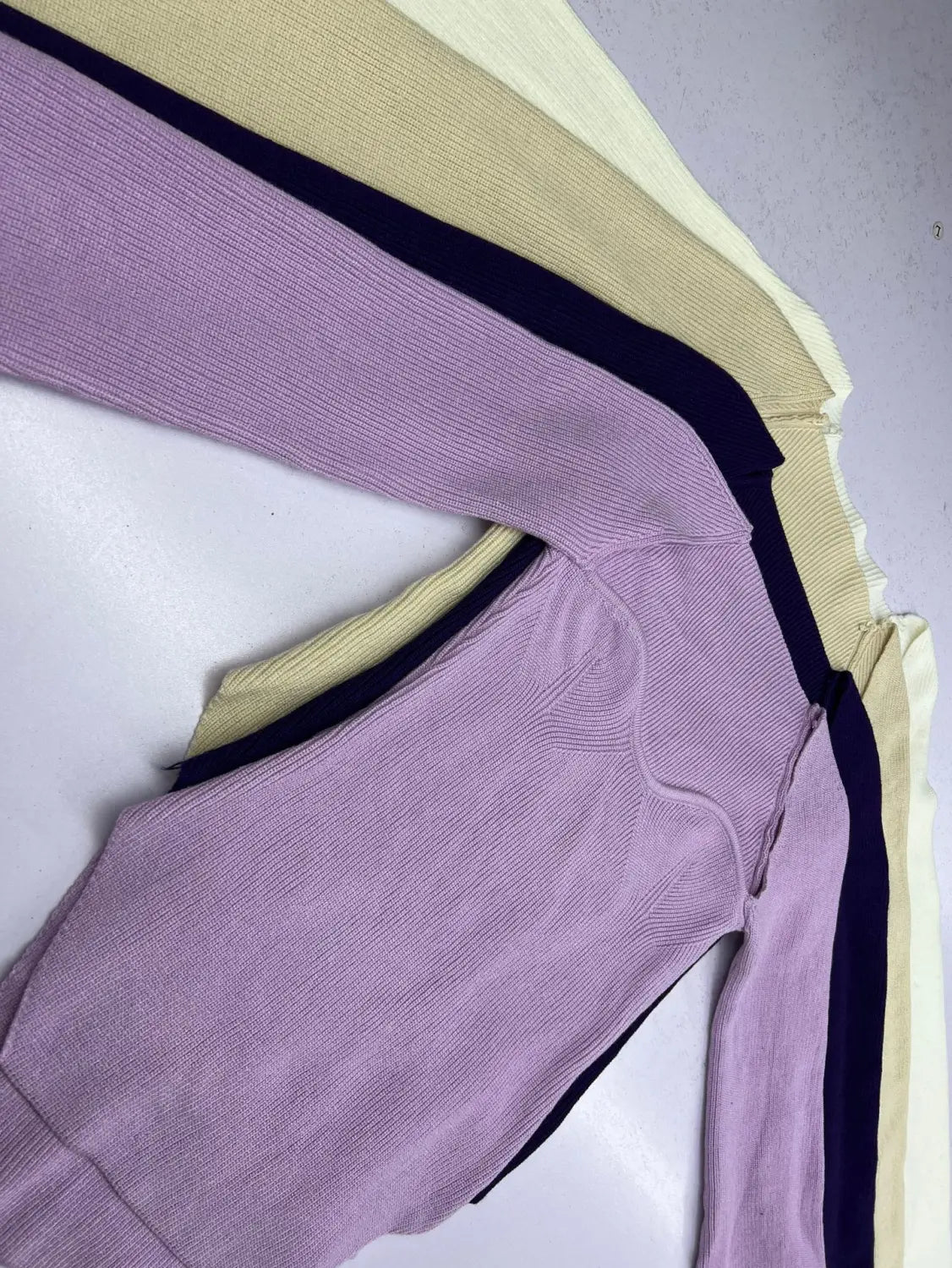 A soft lavender ribbed knit long sleeve pullover with a sweetheart neck and contrasting black side panel.