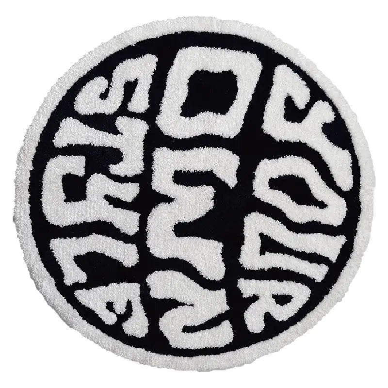 Round plush rug featuring a black and white minimalist design with your own style embroidered in bold textured lettering on a soft plush surface.
