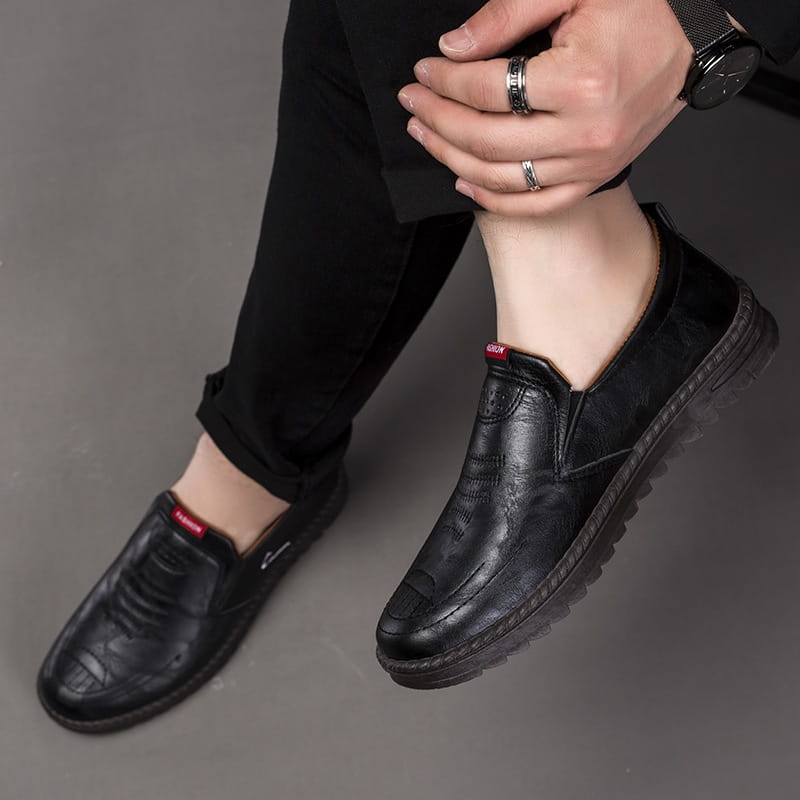 Men’s lightweight breathable white faux leather slip on shoe with brown embroidered detailing and textured rubber sole