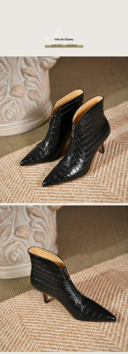 Black croc embossed leather ankle boots featuring a pointed toe and slender stiletto heel.