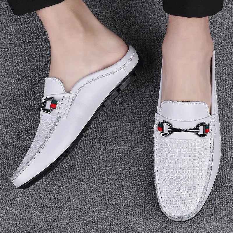 Men’s leather mule loafers in white featuring a woven texture and a black metal horsebit buckle with red green and white accents.