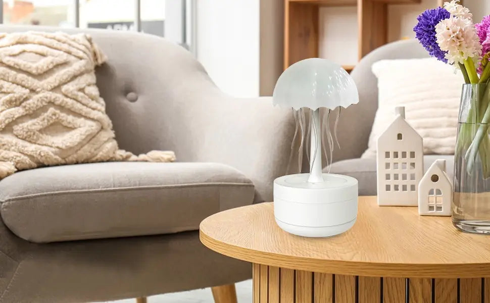 White jellyfish-shaped humidifier with translucent dome and slender stem resting on a circular base featuring 7 color LED essential oil diffuser functions.