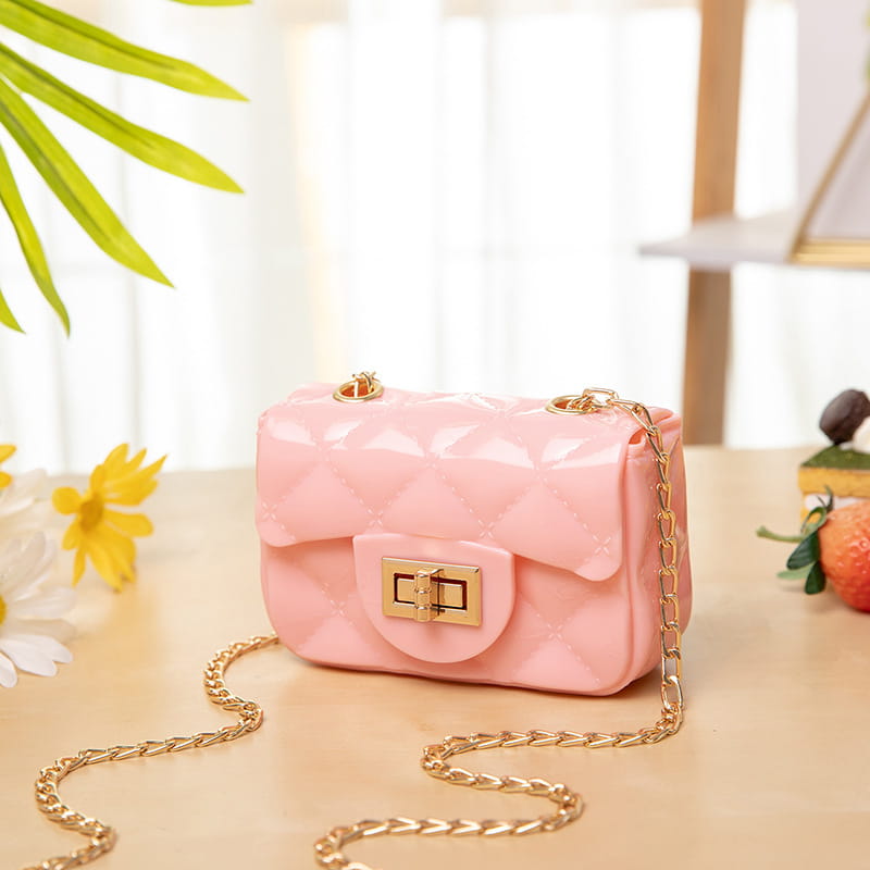 Mini quilted pearl crossbody bag for women in pink quilted gel material with gold-tone chain strap and clasp.