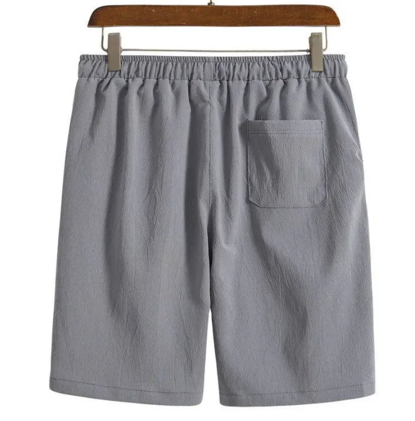 Short de plage en coton lin pour hommes gris présenté de dos, avec une ceinture élastique et une poche arrière unique
