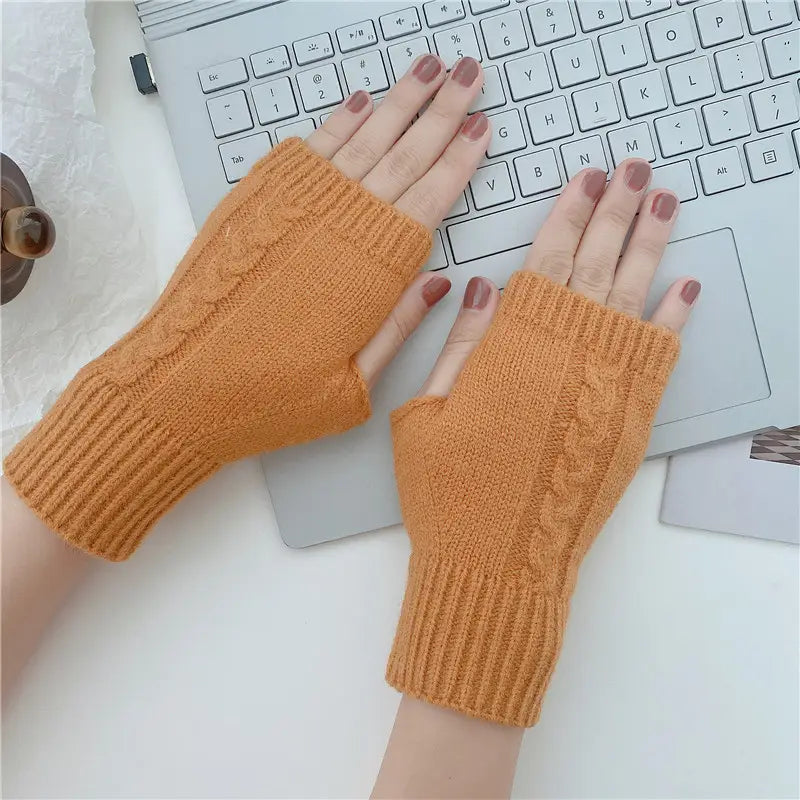 Warm orange unisex woolen cable knit fingerless gloves with ribbed cuff and cable knit pattern.