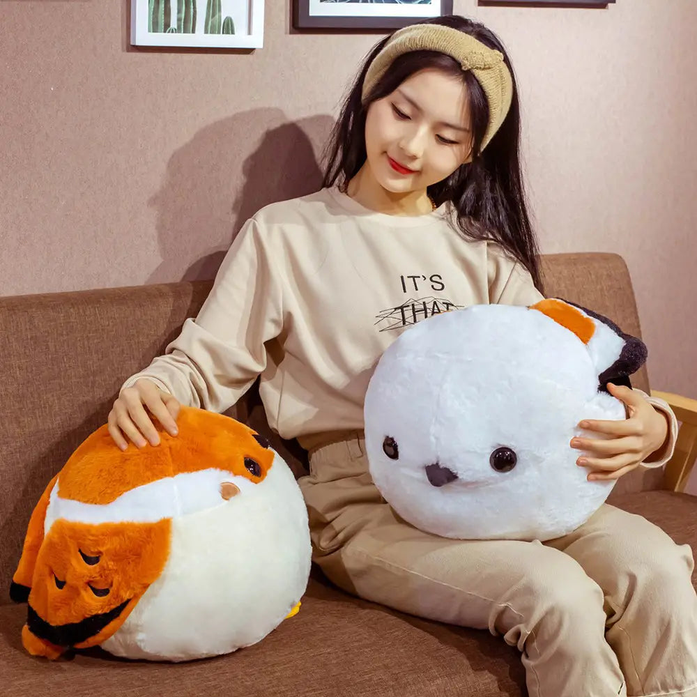 a white and orange sparrow plush bird pillow with black eyes and a small beak made of soft fabric texture ideal as a soft animal doll toy