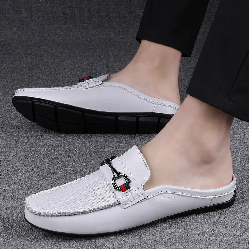 Men’s leather mule loafers in white with a woven texture on the toe and black metal buckle accents.