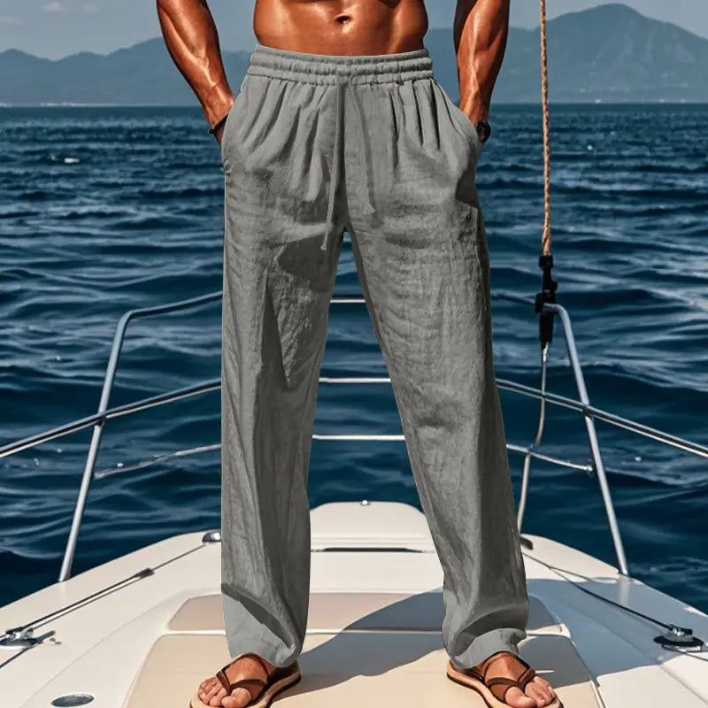 Men’s gray linen joggers with an elastic waistband and side pockets designed for casual wear.