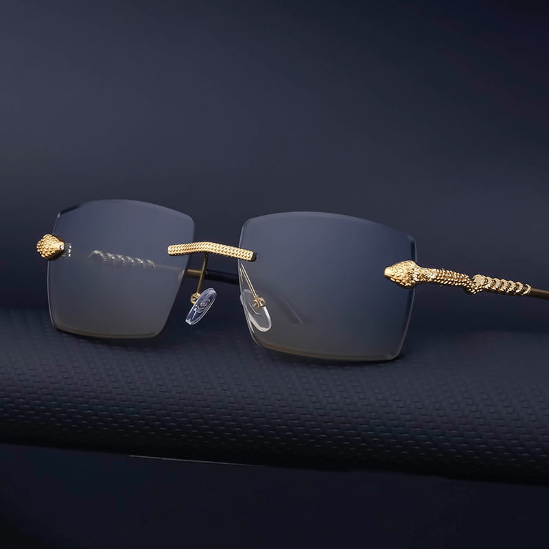 Rimless sunglasses for men with gold-toned snake-embossed frames and gradient gray uv400 lenses.