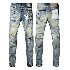 Men’s distressed slim fit patchwork denim jeans feature light-wash denim with faded blue and white patches ripped knees and a raw hem.