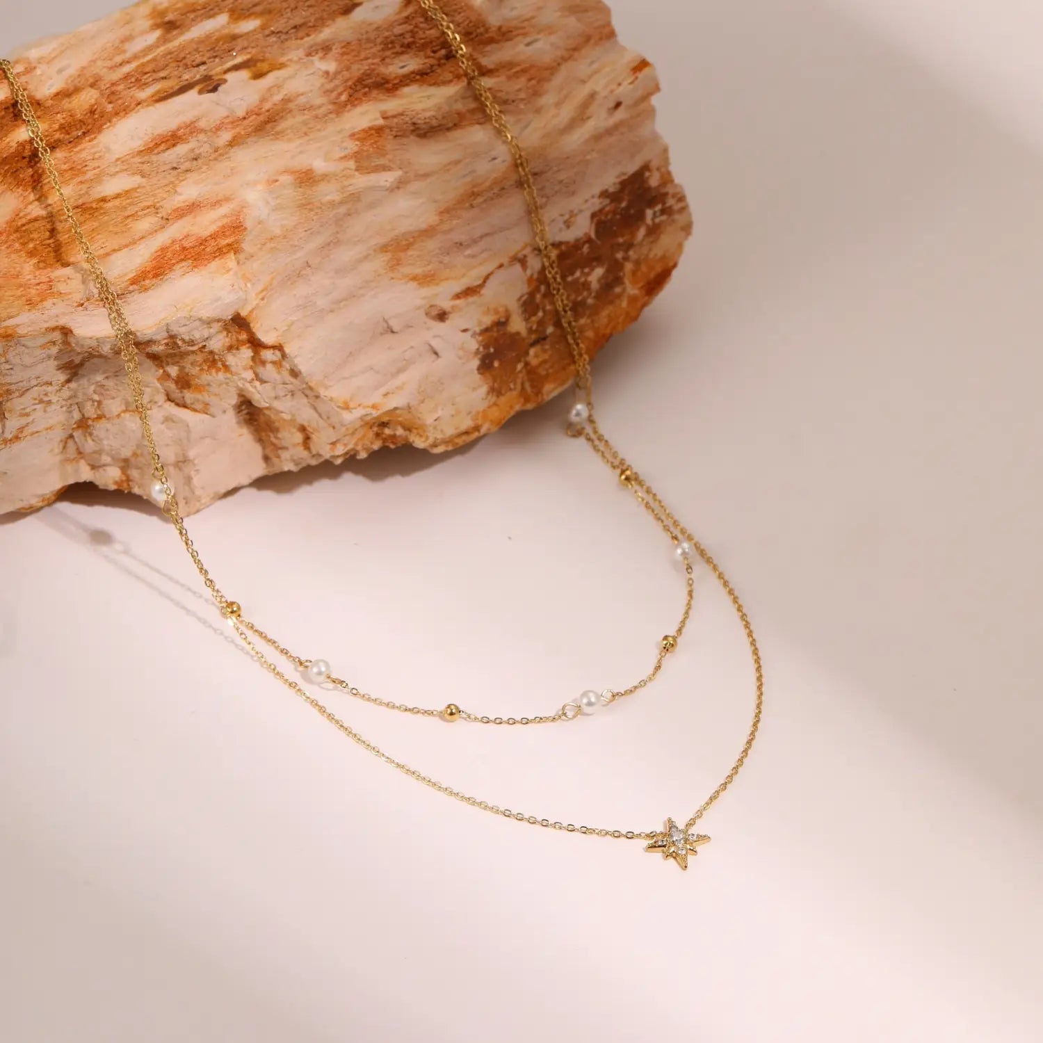 double layer 18k gold star and pearl stainless steel necklace featuring gold-toned delicate chains with alternating pearl and gold bead accents and a sparkling star pendant.