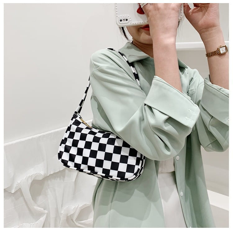 Sac sous-bras en nylon à carreaux noir et blanc, avec un design moderne élégant, issu de la collection à imprimé léopard et à carreaux.