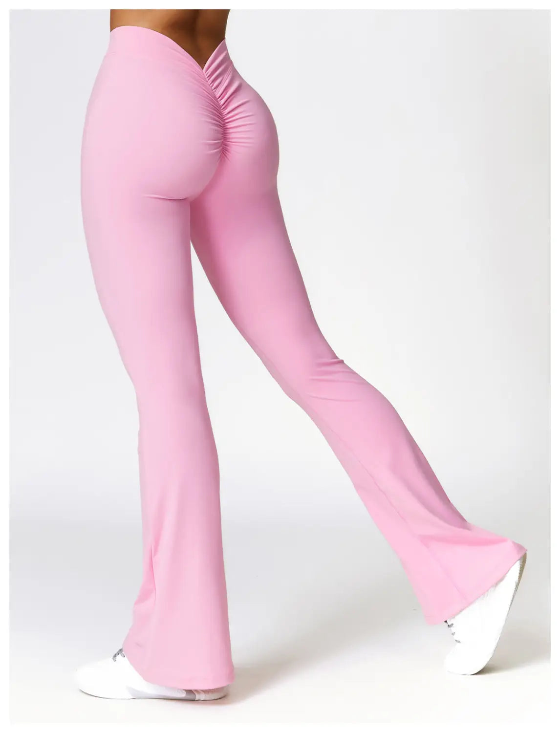 pink high-waisted flared yoga pants with a ruched back design shown from the back in active trousers style