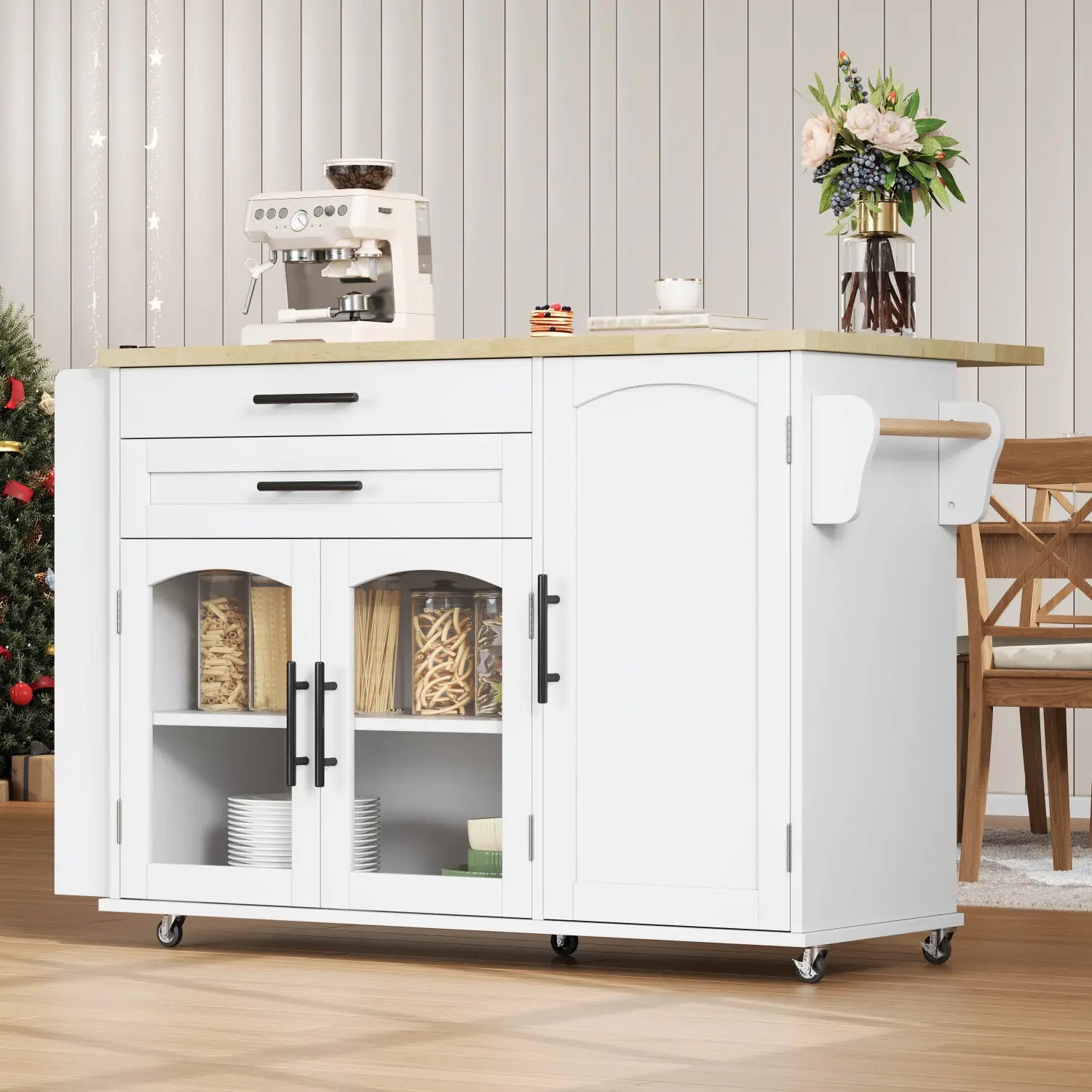 White kitchen cart mobile kitchen island with foldable light wood countertop and black handles featuring glass-fronted cabinets displaying pasta and plates