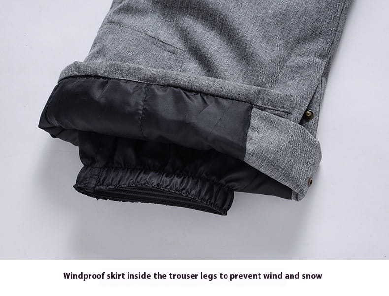 Men waterproof thermal snow pants showing gray textured outer fabric with black windproof skirt lining inside the trouser legs.