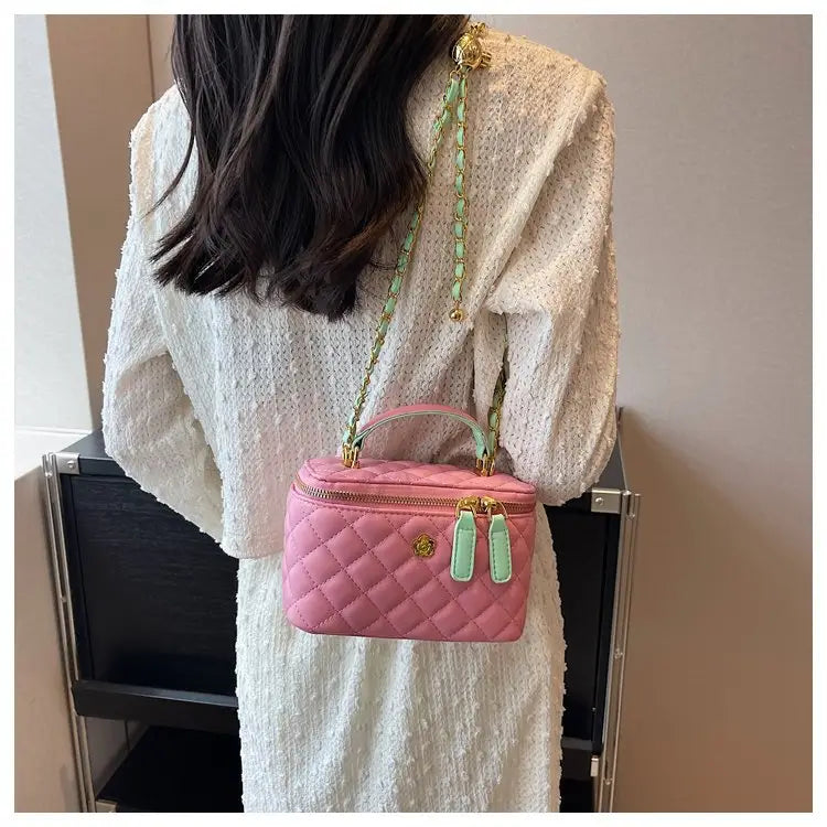 Pink quilted diamond chain crossbody bag made of pu leather with gold-tone hardware and mint green chain strap.