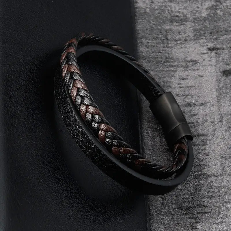 men’s black braided leather bracelet with magnetic clasp shown on a white background.