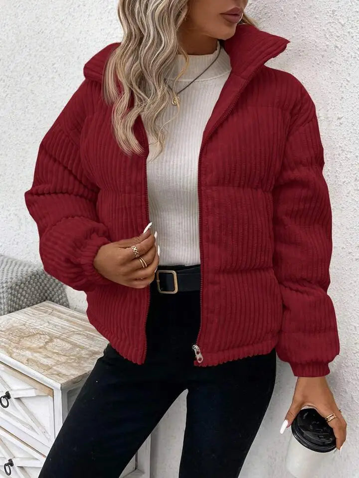 A cozy burgundy corduroy puffer jacket with a high collar and front zipper designed as a plus size women winter coat.
