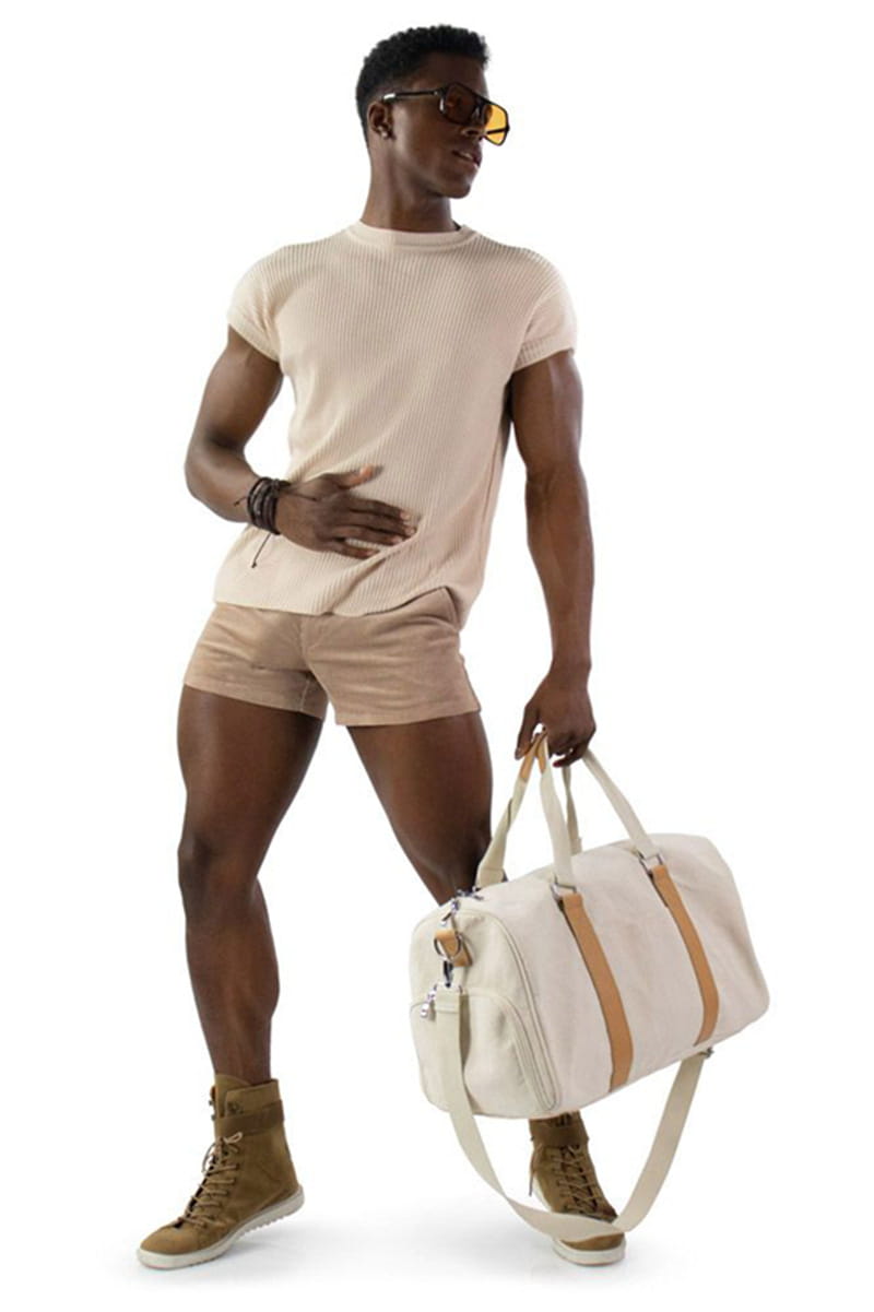 Beige canvas duffel bag with tan leather straps and white shoulder strap featured alongside men corduroy beach shorts casual mid rise.