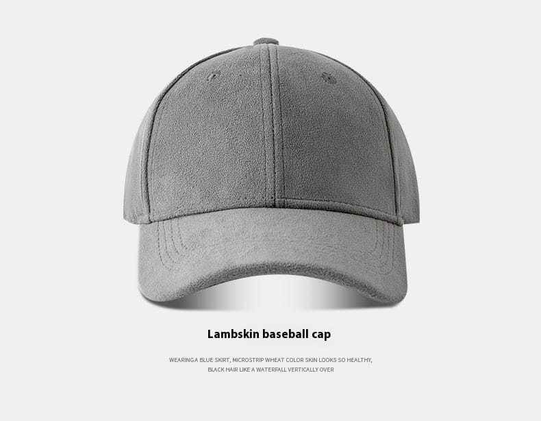 A gray suede baseball cap with a soft textured lambskin surface and classic six-panel construction for an adjustable minimalist hat.