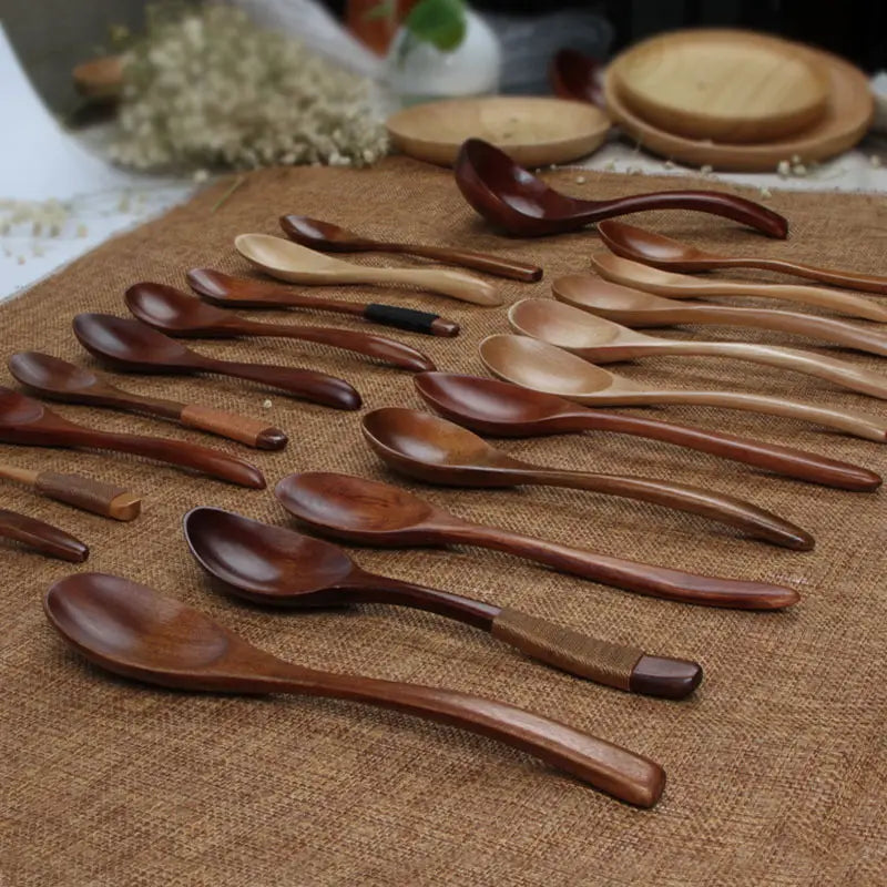 A collection of handcrafted Japanese wooden honey spoons made from rich brown Hemu wood featuring natural wood grain and subtle decorative inlays.