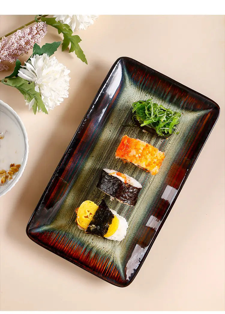 Rectangular ceramic serving tray with a glossy gradient glaze transitioning from deep green to dark brown and red edges measuring 12.5 inches.